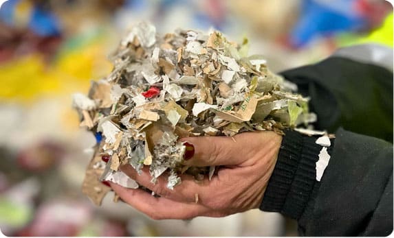 Hands holding recycled material.