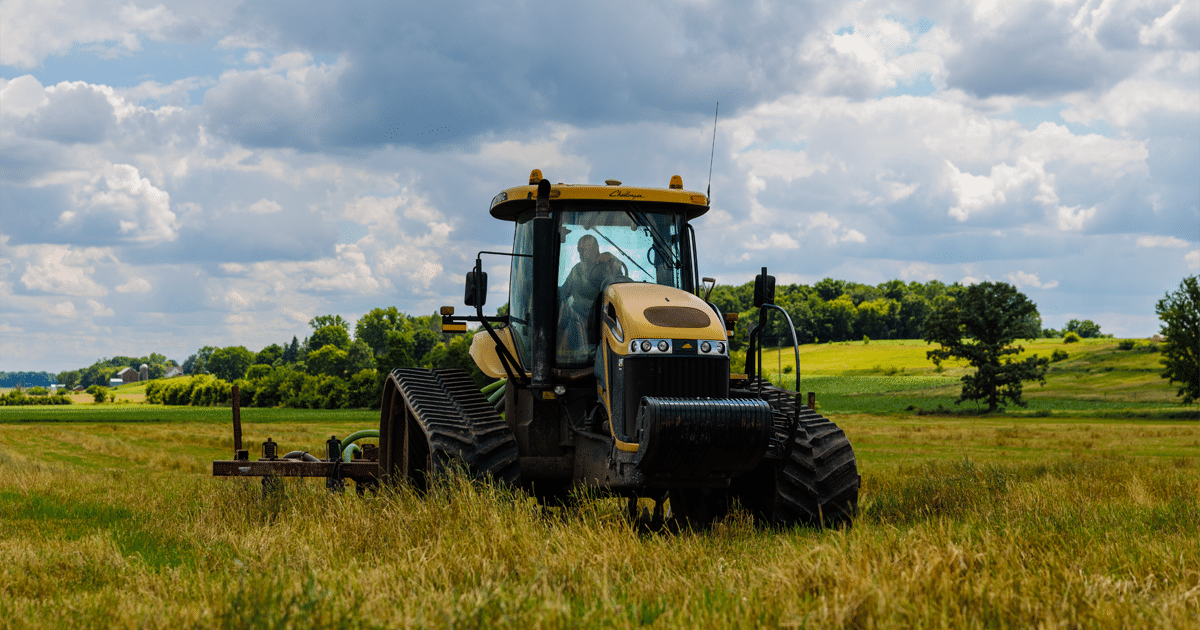 Tractor spreading liquid waste on farm field.